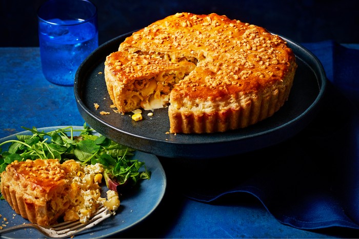 Macaroni sweetcorn pie Macaroni and sweetcorn pie on a cake stand with a slice on a plate next to it