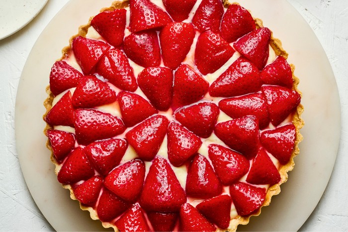 Macerated strawberry custard tart Top down view of a macerated strawberry custard tart