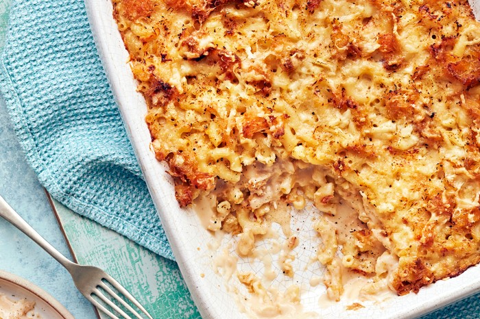 Crab mac 'n' cheese A white oven dish willed with golden mac and cheese on a blue cloth with a silver fork