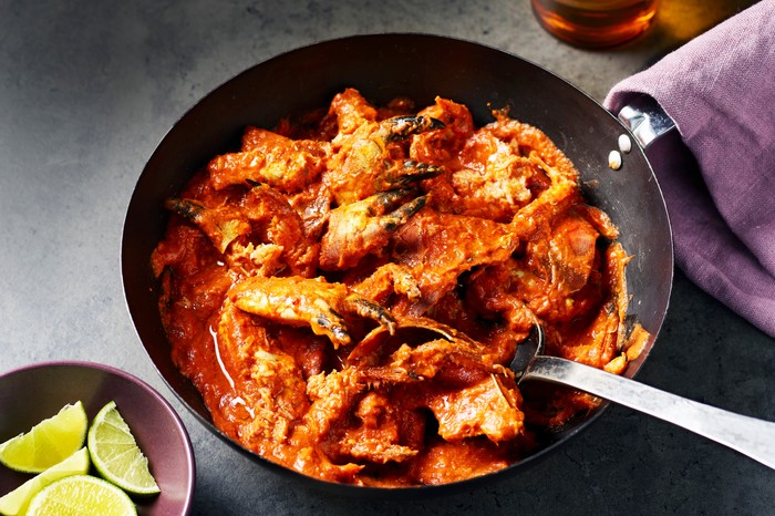 Singapore chilli crab A black wok filled with cooked crab in a red chilli sauce