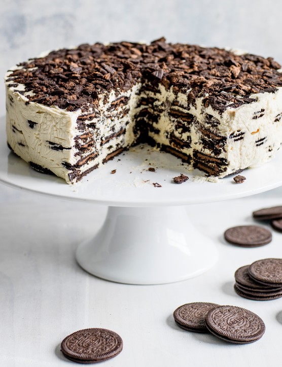 Oreo Baileys Icebox Cake Recipe Oreo Baileys fridge cake, with a large chunk taken out to reveal the layered filling