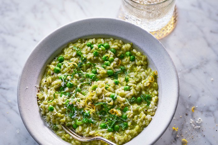 Pea risotto Bowl of pea risotto next to a glass of water
