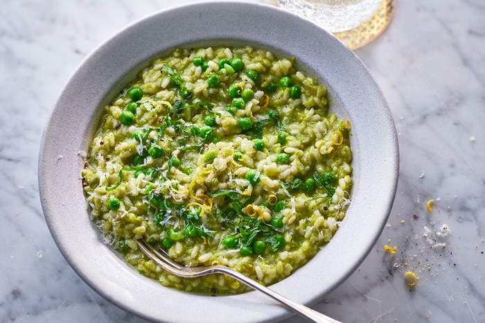 Pea risotto Bowl of pea risotto next to a glass of water