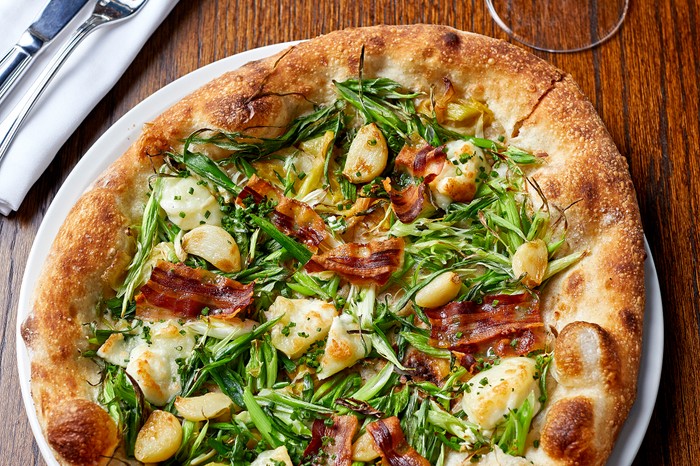 Goat's cheese pizza with leeks and pancetta A puffy pizza base topped with greens, goat's cheese and crispy pancetta