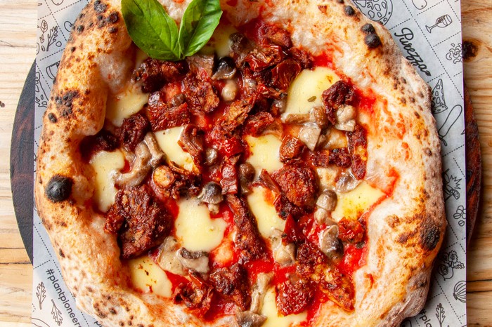 Purezza Pizza A large pizza with a fluffy crust topped with melted vegan cheese