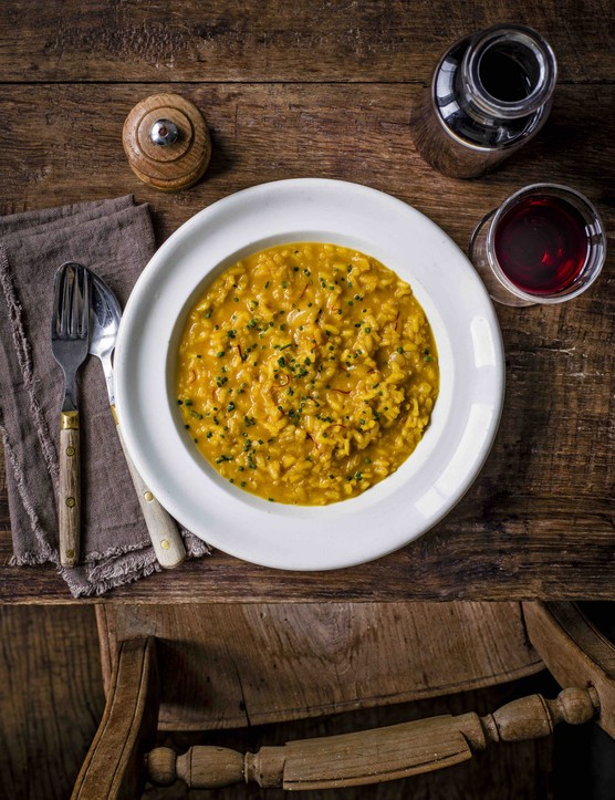 Saffron risotto An aerial shot of saffron-coloured risotto on a white plate