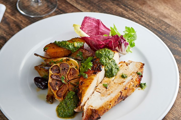 Roast spatchcock chicken mojo rojo Plate of roast chicken with garlic