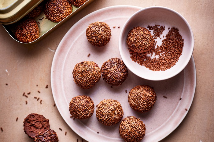 Homemade rum truffles on a pink plate