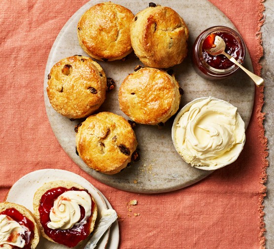 Scones Recipe A plate of scones alongisde a pot of cream and a pot of strawberry red jam