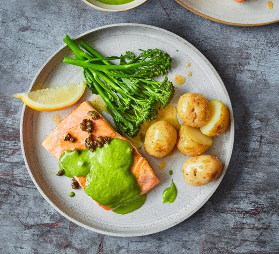 Pan-fried salmon with watercress sauce A plate of salmon, new potatoes, broccoli and watercress sauce