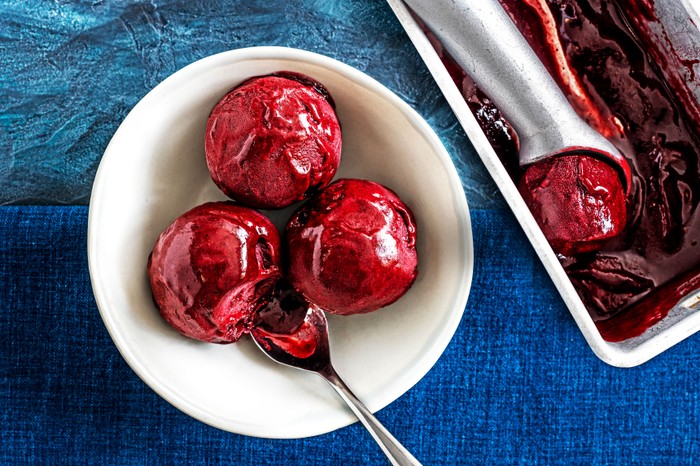 Sorbet Blackberry and mint sorbet in a white bowl on a dark blue table cloth