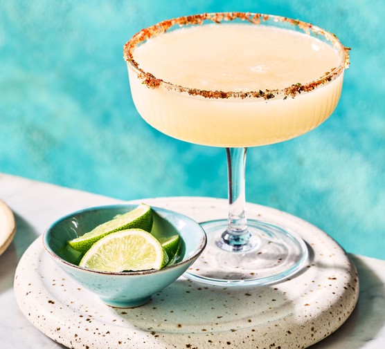 spicy margarita Spicy margarita in glass with lime wedges in bowl