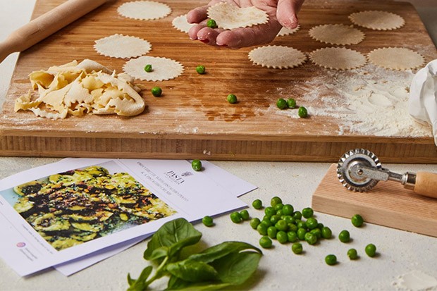 Vegan Pasta Making Kit A wooden board with fresh pasta being rolled out and cut into shapes